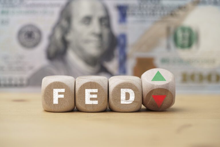 FED print screen on wooden cube block with up down arrow and US dollar banknote background for interest rate increase and decrease   concept